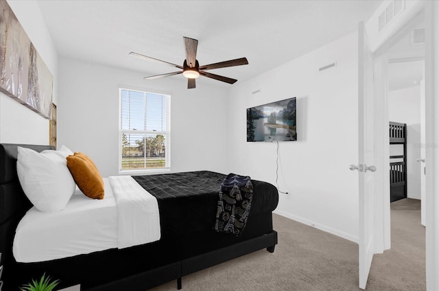 bedroom featuring carpet floors, ceiling fan, visible vents, and baseboards