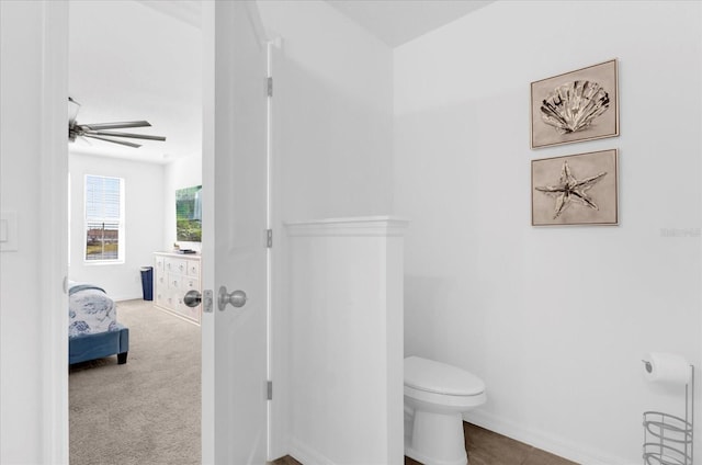 bathroom featuring baseboards and toilet