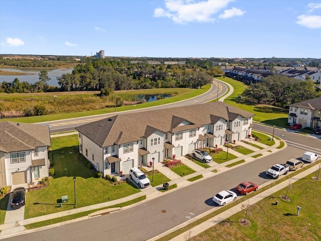 birds eye view of property featuring a water view and a residential view