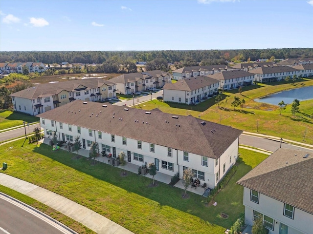 drone / aerial view with a water view and a residential view