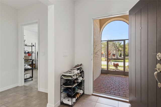 tiled foyer featuring baseboards