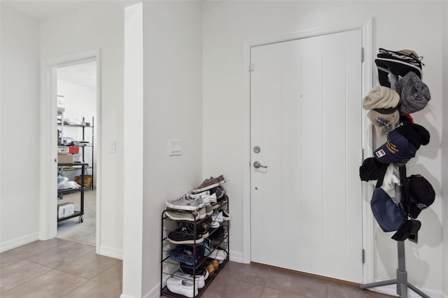 tiled entrance foyer with baseboards