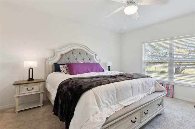 bedroom featuring baseboards, ceiling fan, and light colored carpet