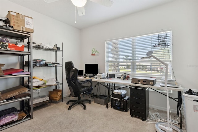 carpeted office space featuring ceiling fan