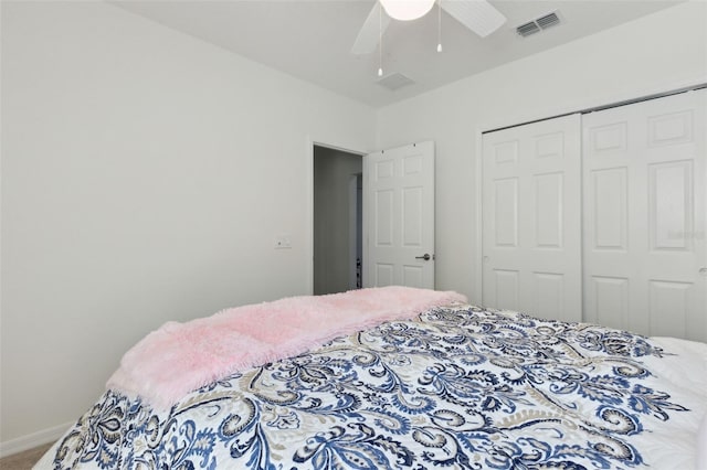 carpeted bedroom with visible vents, a closet, a ceiling fan, and baseboards