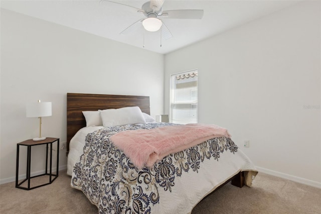 carpeted bedroom featuring ceiling fan and baseboards