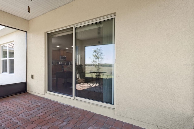 property entrance featuring stucco siding