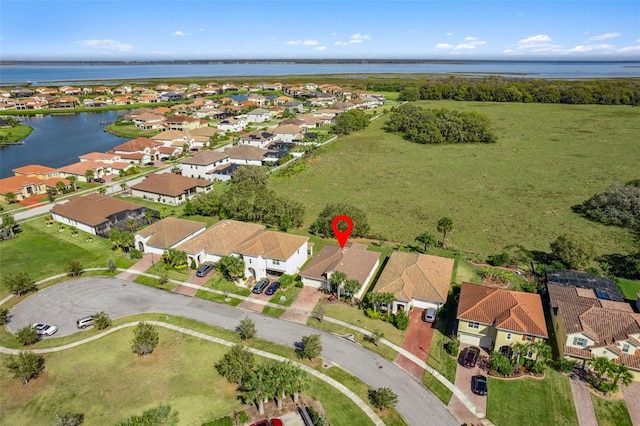 drone / aerial view featuring a residential view and a water view