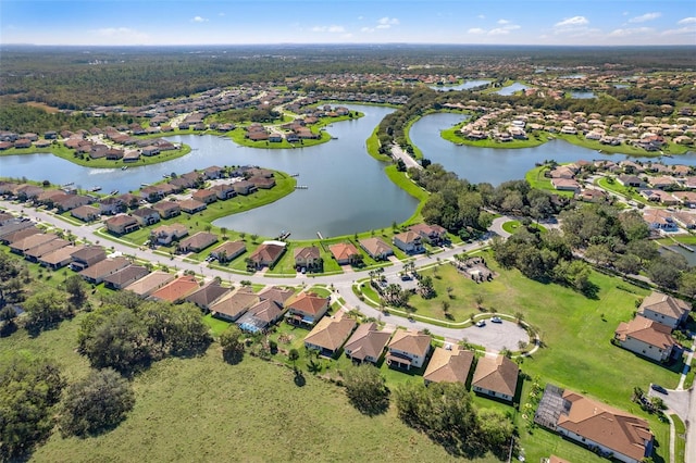 birds eye view of property featuring a water view and a residential view