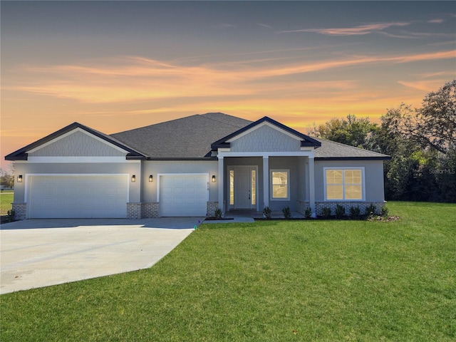 view of front of house featuring a garage, concrete driveway, a front lawn, and brick siding