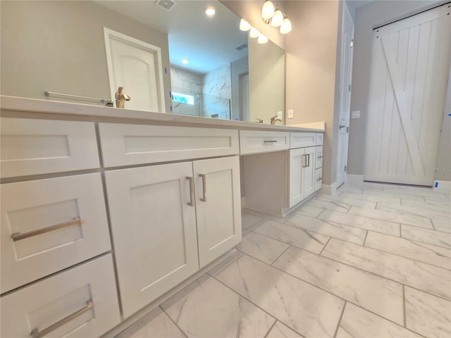 full bathroom featuring double vanity, a stall shower, baseboards, marble finish floor, and recessed lighting