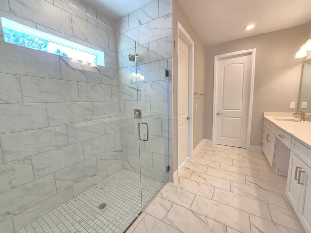 full bath with marble finish floor, a shower stall, baseboards, and vanity