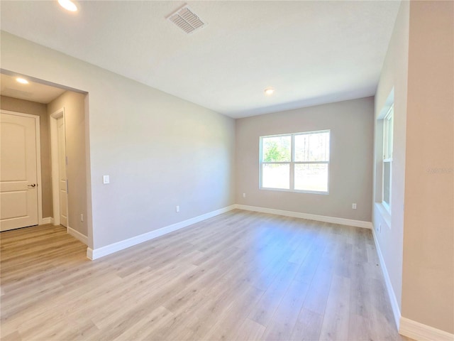 unfurnished room with baseboards, recessed lighting, visible vents, and light wood-style floors