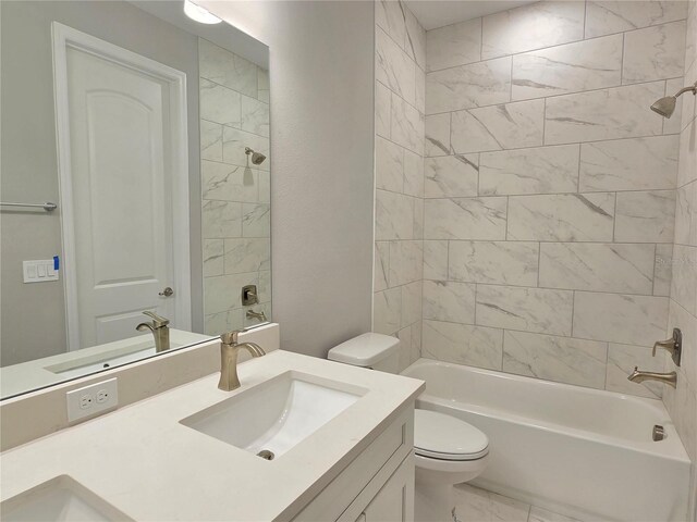 bathroom with toilet, marble finish floor, shower / bathing tub combination, and vanity