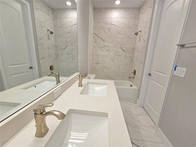 full bathroom with marble finish floor, double vanity, a sink, and bathing tub / shower combination