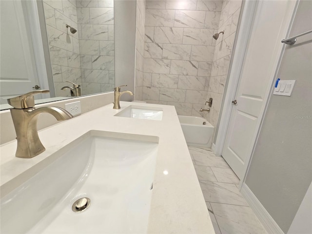 bathroom featuring marble finish floor, tub / shower combination, a sink, and double vanity