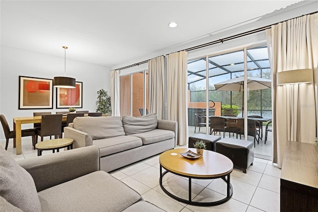 living area featuring light tile patterned floors, a sunroom, and recessed lighting