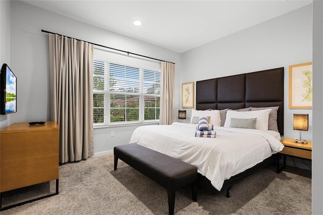 bedroom with light carpet and baseboards