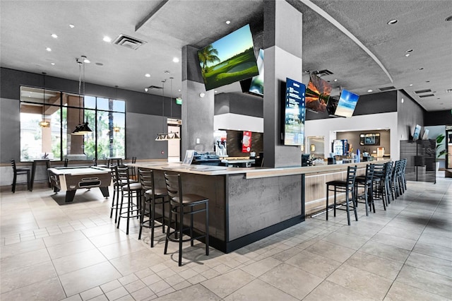 kitchen featuring light tile patterned floors, billiards, visible vents, and decorative light fixtures