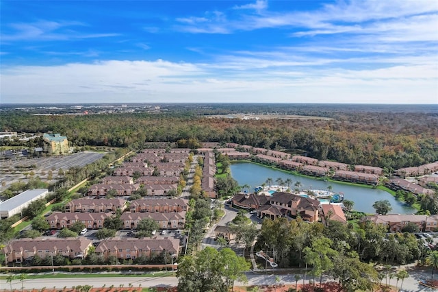 drone / aerial view with a water view and a residential view