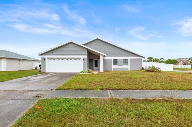 view of front of house featuring a garage, fence, concrete driveway, and a front yard