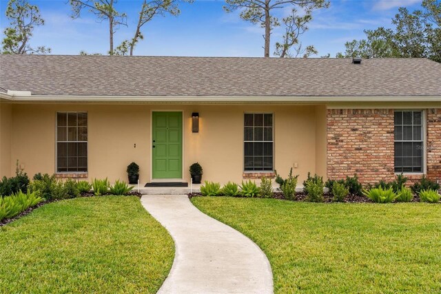 1581 Monica Joy Cir, Longwood, FL 32779 - single story home with brick siding, a shingled roof, stucco siding, and a front yard