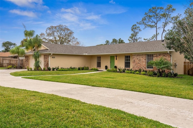 1581 Monica Joy Cir, Longwood, FL 32779 - view of front facade with brick siding, fence, concrete driveway, and a front yard