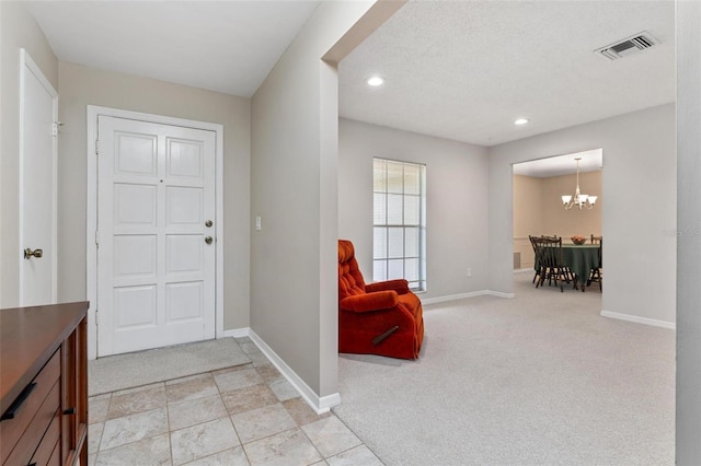 1581 Monica Joy Cir, Longwood, FL 32779 - foyer entrance featuring light carpet, an inviting chandelier, visible vents, and baseboards