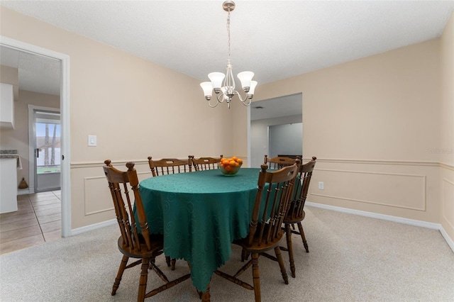 1581 Monica Joy Cir, Longwood, FL 32779 - dining room featuring a wainscoted wall, light colored carpet, a decorative wall, and an inviting chandelier