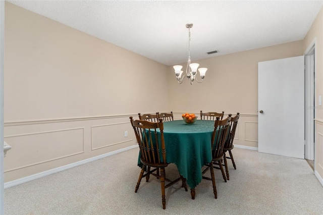 1581 Monica Joy Cir, Longwood, FL 32779 - dining room featuring a decorative wall, light carpet, a wainscoted wall, visible vents, and an inviting chandelier