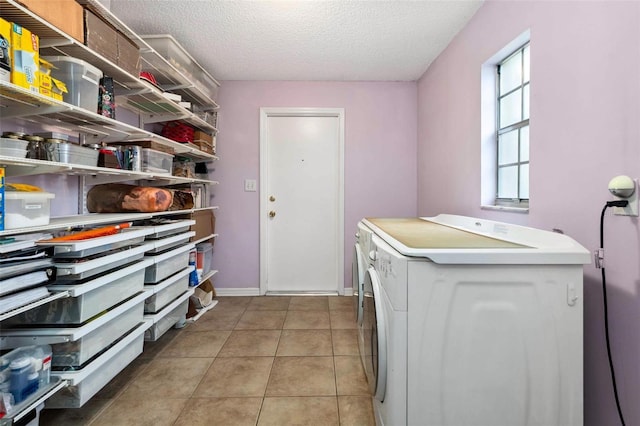 1581 Monica Joy Cir, Longwood, FL 32779 - clothes washing area featuring washer and clothes dryer, light tile patterned floors, a textured ceiling, laundry area, and baseboards