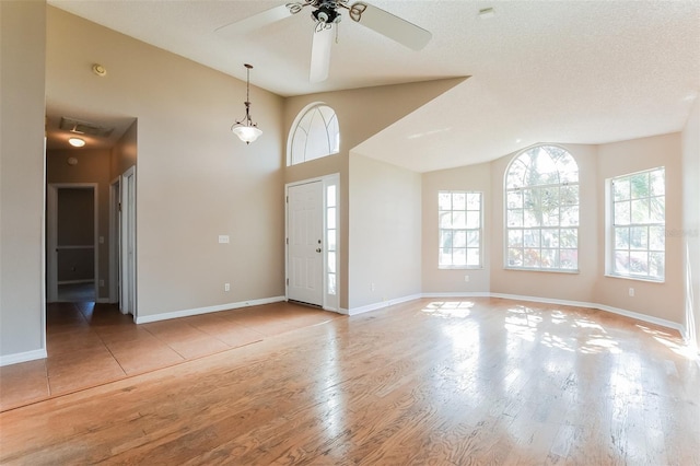 entrance foyer featuring light wood-style floors, visible vents, and a wealth of natural light