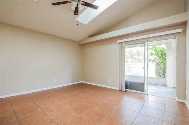 empty room featuring lofted ceiling with skylight, light tile patterned flooring, ceiling fan, and baseboards