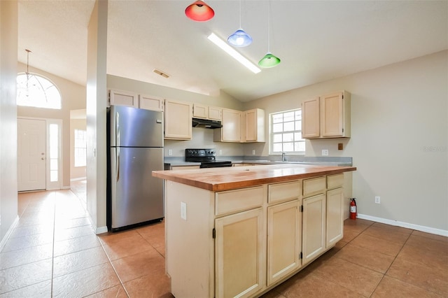 kitchen featuring under cabinet range hood, black / electric stove, freestanding refrigerator, and pendant lighting