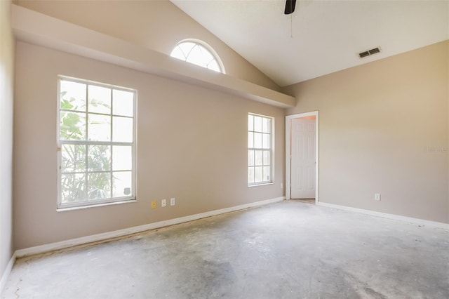 unfurnished room with lofted ceiling, ceiling fan, concrete flooring, visible vents, and baseboards