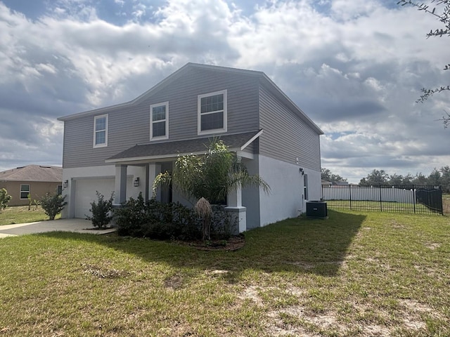 137 Willow Dr, Kissimmee, FL 34759 - view of front of property featuring central AC unit, an attached garage, driveway, and stucco siding