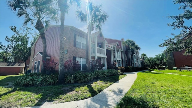 view of side of home with a lawn