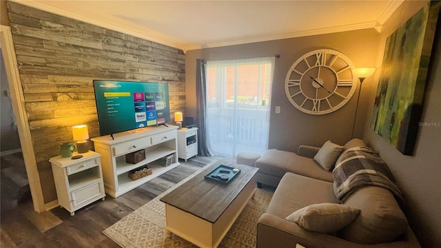 living room with dark wood-type flooring, wood walls, and crown molding