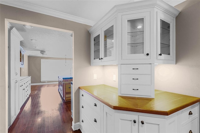 kitchen with glass insert cabinets, dark wood-style flooring, white cabinets, and a textured ceiling