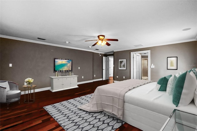 bedroom with crown molding, wood finished floors, visible vents, and baseboards