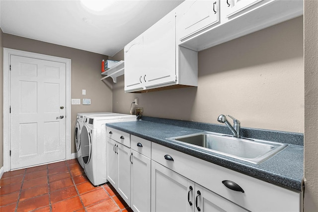 laundry room with dark tile patterned floors, independent washer and dryer, a sink, and cabinet space