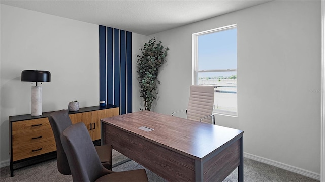 home office featuring carpet flooring, a textured ceiling, and baseboards