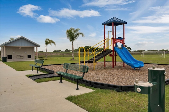 community jungle gym with a lawn