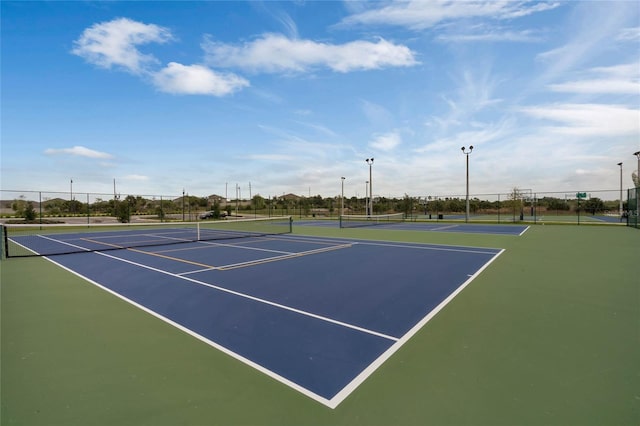 view of sport court featuring fence