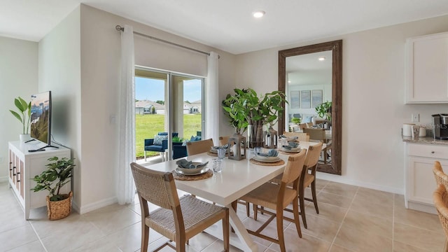 dining room with recessed lighting, light tile patterned flooring, and baseboards