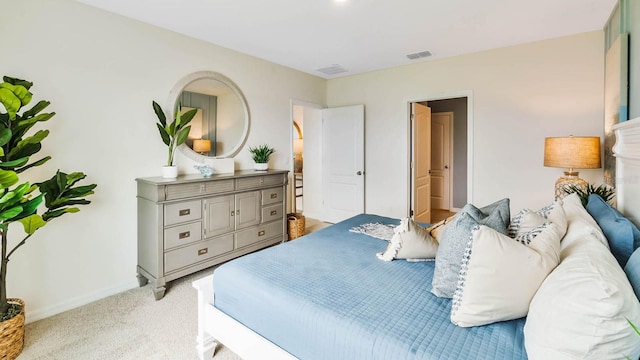 bedroom featuring light carpet, visible vents, and baseboards