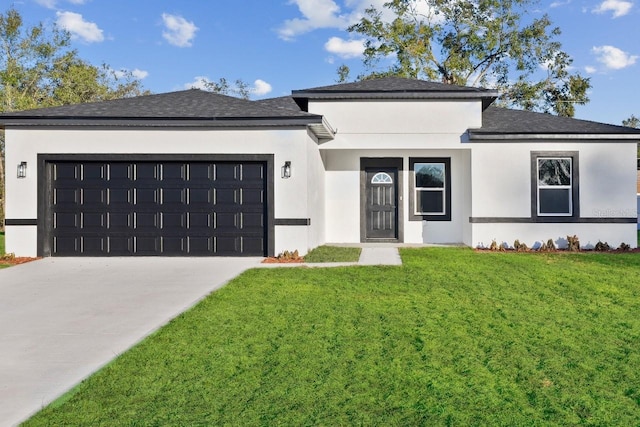 view of front of home featuring a garage, concrete driveway, a front lawn, and stucco siding