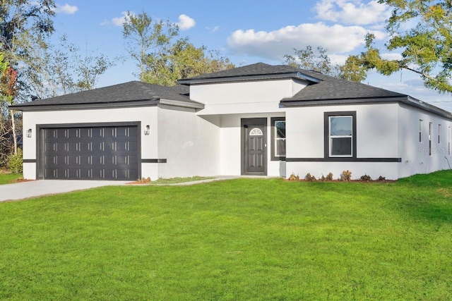 prairie-style house with a garage, a front lawn, and stucco siding