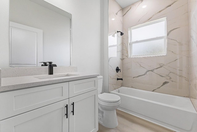 bathroom with toilet, vanity, shower / tub combination, and wood finished floors