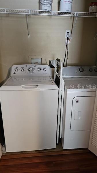 2019 Dixie Belle Dr Unit 2019O, Orlando, FL 32812 - clothes washing area with laundry area, dark wood-type flooring, and washing machine and clothes dryer